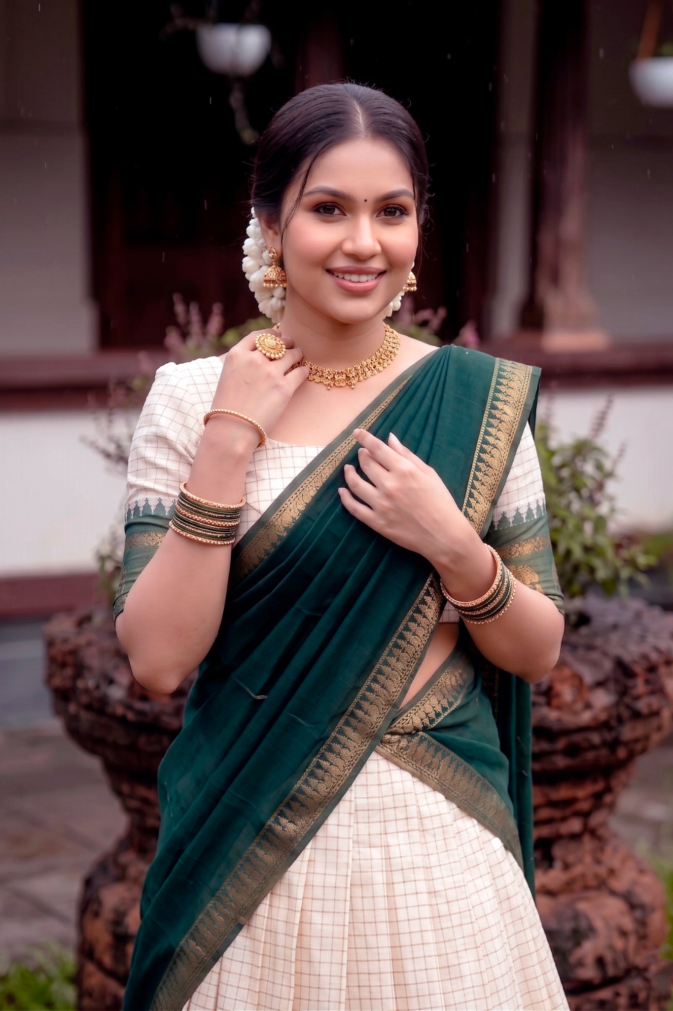 Woman in traditional attire with a green lehenga choli