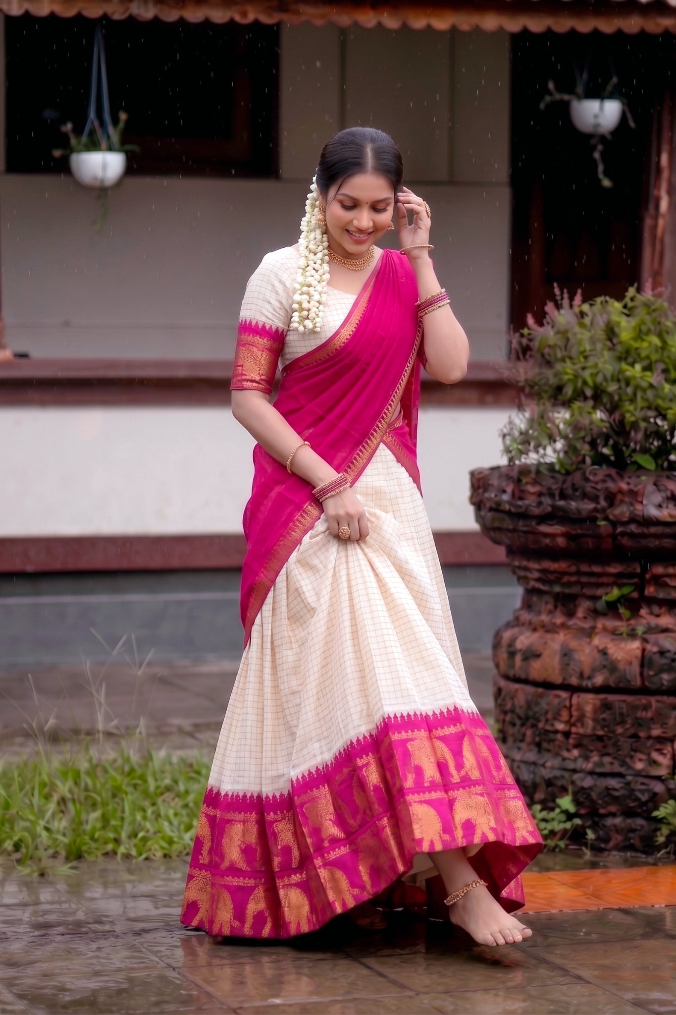 Woman in a pink and white lehenga standing outdoors