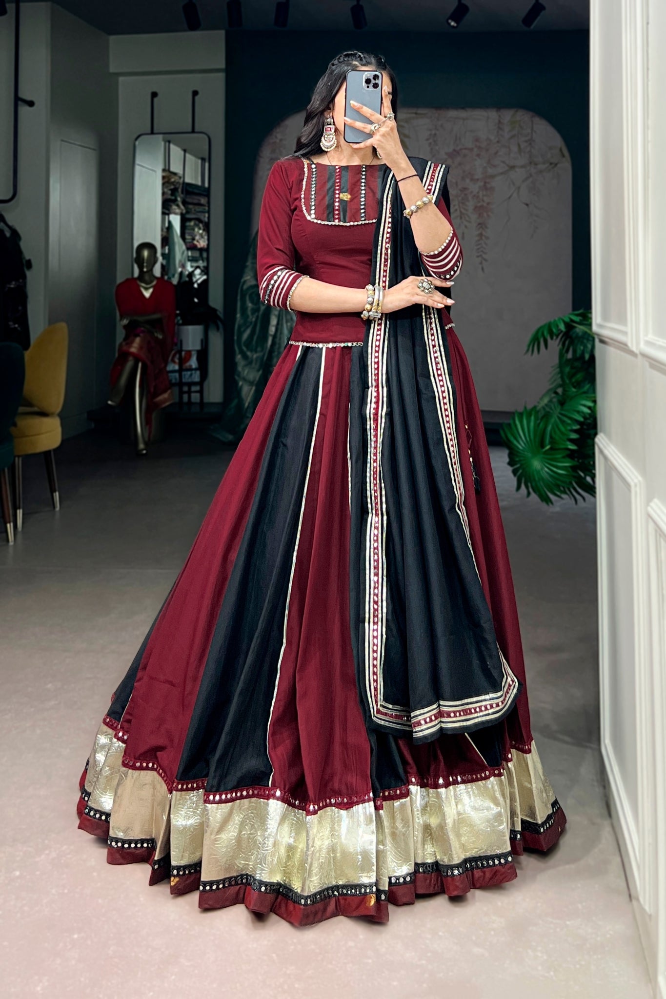 Woman wearing a maroon and black traditional navratri outfit