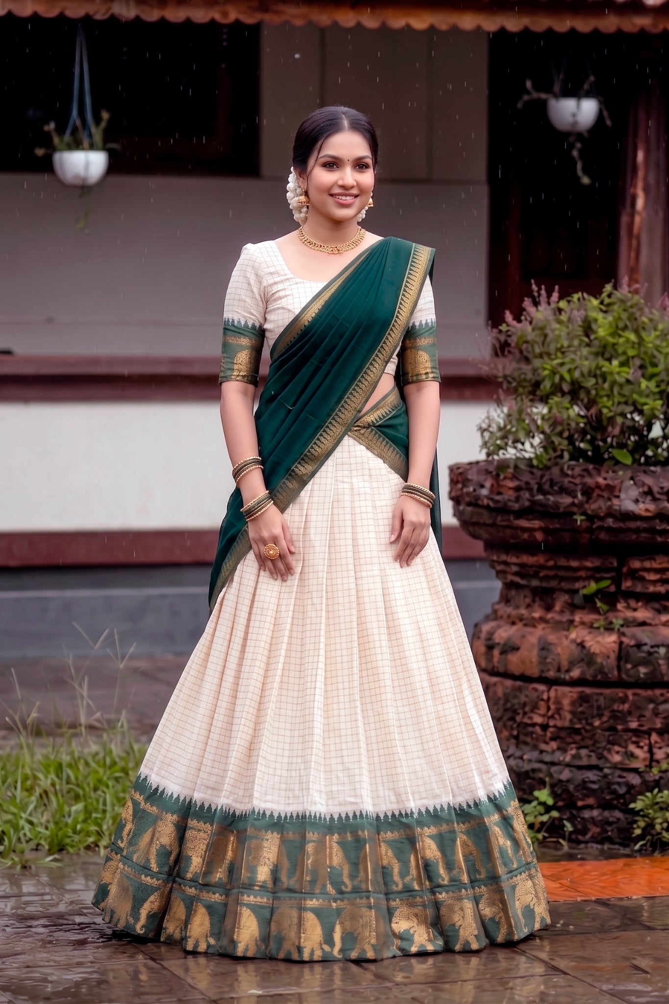Woman wearing a traditional lehenga with a green and white pattern in an outdoor setting.