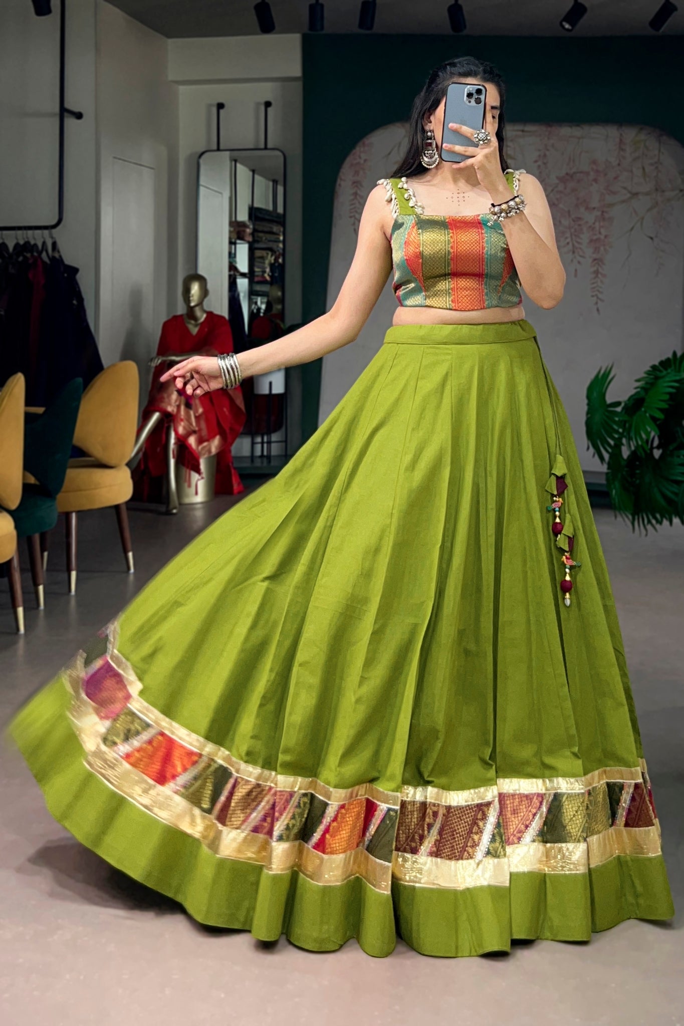 Woman wearing a parrot green traditional outfit with colorful details 